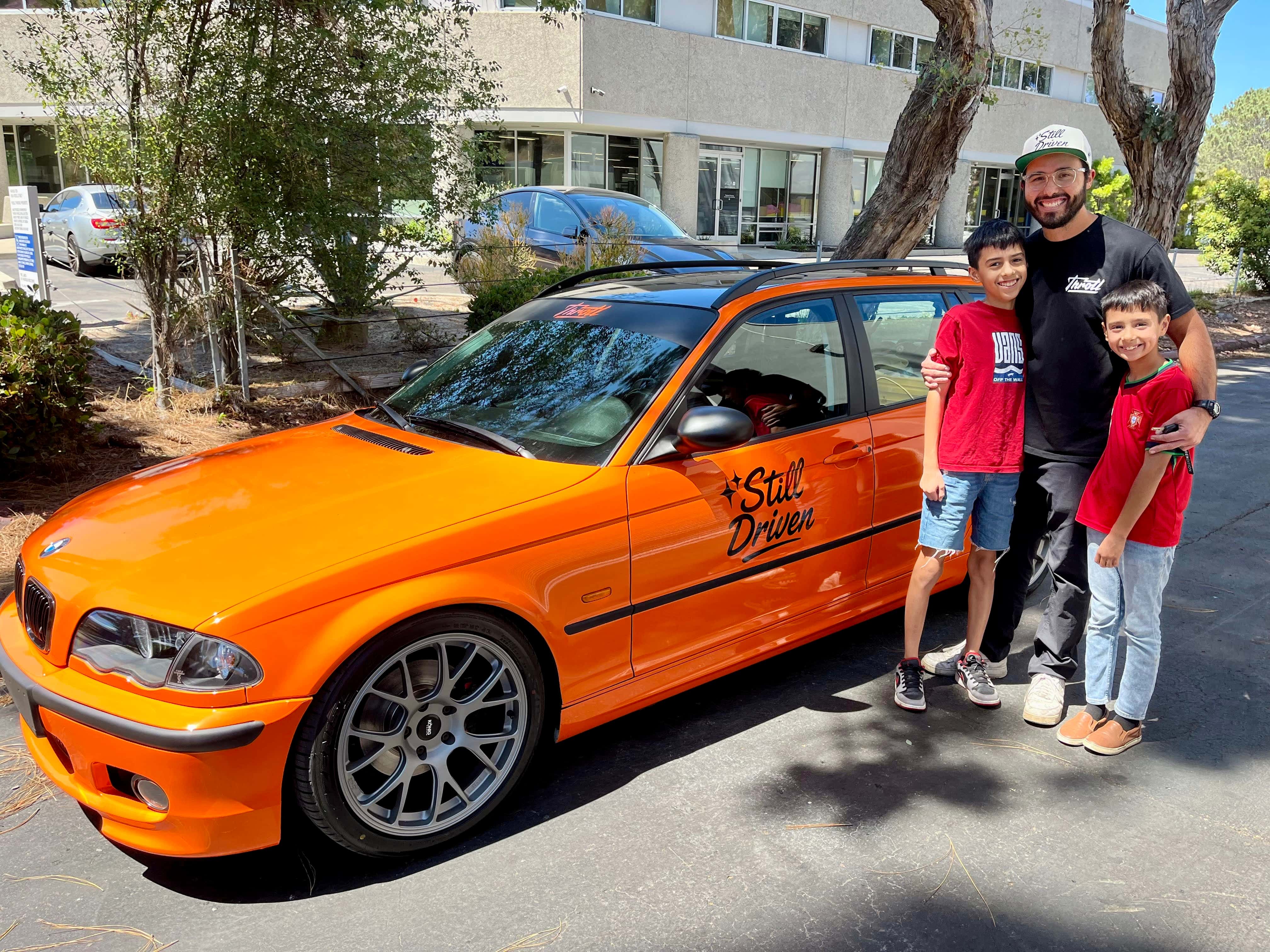 Detailer carefully applying ceramic coating by hand to a black vehicle