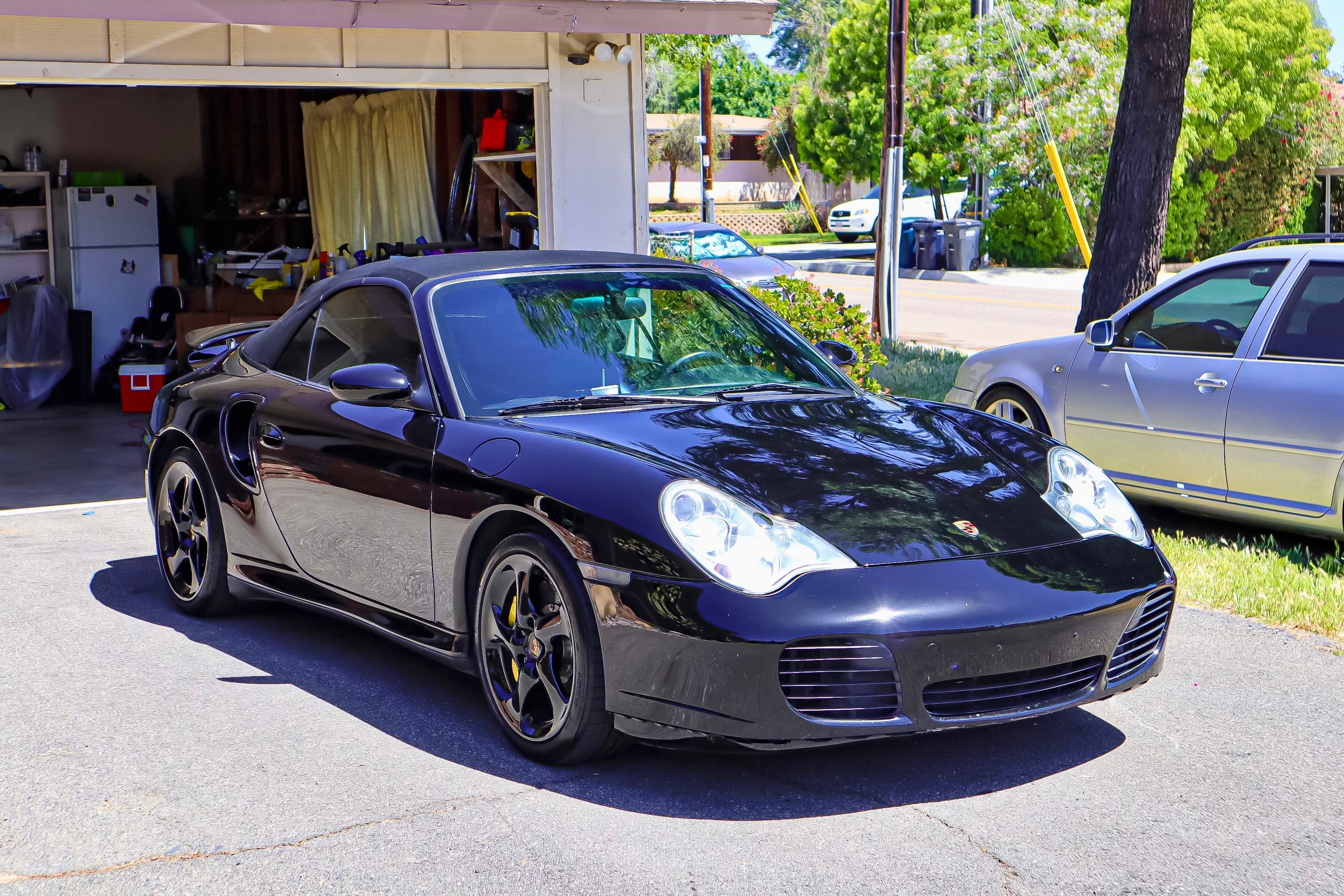 Water beading on black ceramic-coated paint — hydrophobic effect after professional ceramic coating