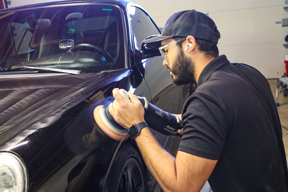 Before: paint correction stage on BMW hood under professional lighting